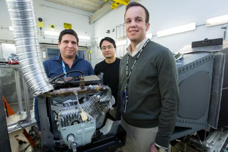Researchers used neutrons to probe a running engine at Oak Ridge National Laboratory’s Spallation Neutron Source, giving them the opportunity to test an aluminum-cerium alloy under operating conditions. From left, researchers Orlando Rios, Ke An, and Eric Stromme show off a cylinder head made from the new alloy. (Photo by ORNL/U.S. Department of Energy)