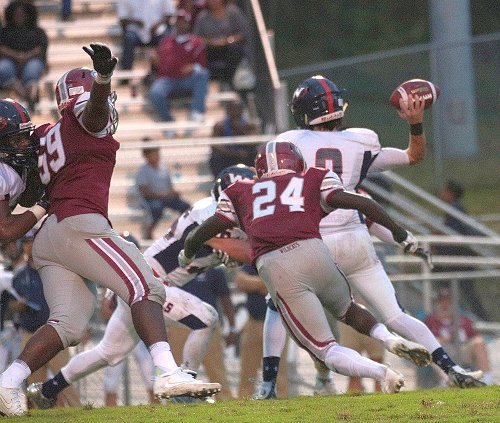 Oak Ridge senior Adarius Simpson (24) and junior TJ Johnson (59) rush the West quarterback during a game at home on Blankenship Field on Friday, Sept. 15, 2017. (Photo by Luther Simmons)