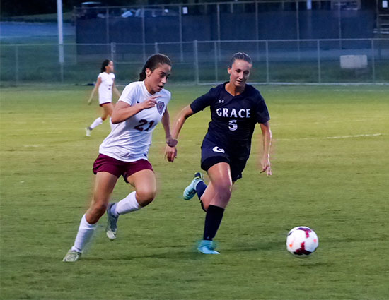 Pictured above racing for the ball during a 3-1 win over Grace Christian at Oak Ridge High School on Tuesday, Aug. 29, 2017, is sophomore Maddie Peters (21). (Photo by John Huotari/Oak Ridge Today)