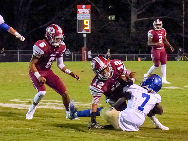 Oak Ridge junior wide receiver Kai'Reese Pendergrass (12) is tackled by Karns sophomore Trey Hawkins (7) during a 49-3 homecoming win for the Wildcats on Blankenship Field on Friday, Sept. 29, 2017. Also pictured are Oak Ridge seniors Jaycen McGhee (6) and Johnny Stewart (2). (Photo by John Huotari/Oak Ridge Today)