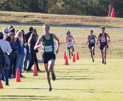 Oak Ridge senior Jose Villegas, at right in background, finished second in the boys 5,000-meter cross country race in the Region 2 Large Division Championships at Victor Ashe Park in Knoxville on Thursday, Oct. 26, 2017. Villegas finished about six seconds behind Jake Renfree of Knoxville Catholic, left. (Photo by Wallace Bowden)