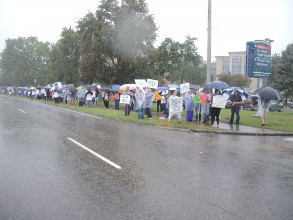 Members of Service Employees International Union Local 205 rallied in front of Methodist Medical Center during a heavy rain on Sunday, Oct. 8, 2017, to protest the state of negotiations on a new three-year contract. The rally included about 150 people, and the crowd stretched over a block. (Photo submitted by SEIU)