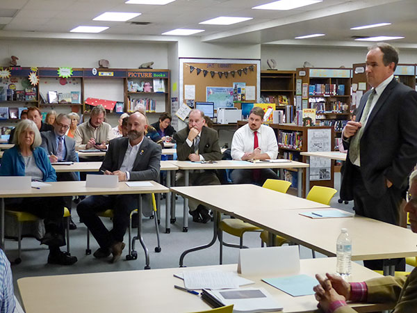Dale Christenson, Uranium Processing Facility federal project director, standing at right, talks to Oak Ridge City Council during a non-voting work session in the Jefferson Middle School Library on Tuesday, Nov. 7, 2017. In the background are city staff members and members of the public. (Photo by John Huotari/Oak Ridge Today)