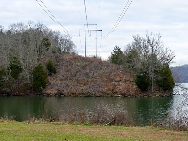 Oak Ridge Electric Director Jack Suggs said this 77-foot-high power pole on Haw Ridge near the fishing pier at Solway Park would be roughly the same size as the transmission towers that could be erected on top of Pine Ridge for a new electrical substation at the Y-12 National Security Complex. The 105-foot right-of-way here would be similar to the right-of-way on Pine Ridge. (Photo by John Huotari/Oak Ridge Today)