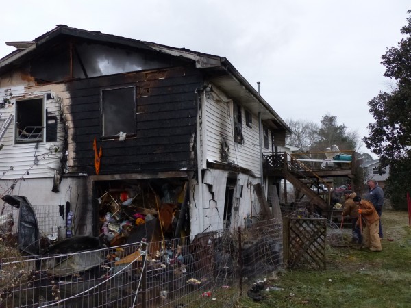 A man escaped with minor injuries, but a home was destroyed in a fire on Friday morning, Jan. 5, 2018, on Lindale Lane in west Oak Ridge. Part of the house where a block wall had buckled was in danger of collapsing, and the Oak Ridge Utility District was digging up a gas line to shut it off. (Photo by John Huotari/Oak Ridge Today)
