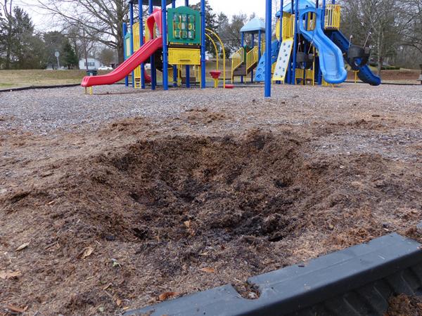 The Oak Ridge Police Department found a small crater that might have been caused by an explosion at Milt Dickens Park in east Oak Ridge late Monday afternoon, Jan. 15, 2018. The crater pictured here on Tuesday morning measured about 4.5 feet across and one foot deep, but the hole had been enlarged by officers taking dirt samples during the investigation. (Photo by John Huotari/Oak Ridge Today)