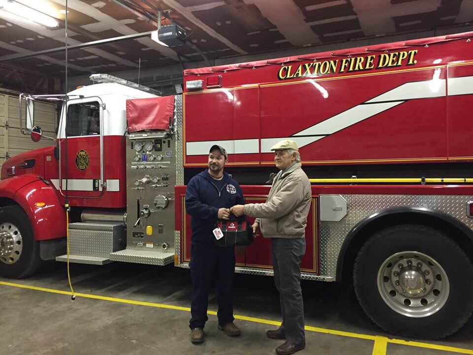 Claxton resident Leo York, right, presents Claxton Volunteer Fire Department Chief Dusty Sharpe with a pet rescue kit used to treat small animals and house pets suffering from smoke inhalation and other medical emergencies. (Submitted photo)