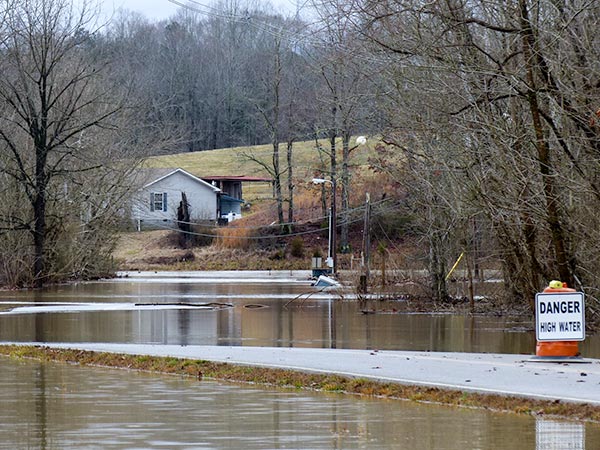 A man escaped from a vehicle in flood water on Airport Road on the east side of Oliver Springs on Saturday night, Feb. 10, 2018, authorities said. The vehicle, reported to be a Jeep, was submerged under flood water at one time, but its top was visible early Sunday afternoon. (Photo by John Huotari/Oak Ridge Today)
