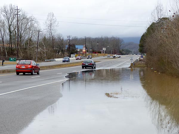Flood waters from Indian Creek cover one of the two northbound lanes of East Tri County Boulevard in Oliver Springs on Sunday, Feb. 11, 2018. (Photo by John Huotari/Oak Ridge Today)