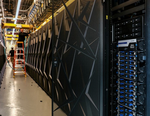 Installation of the Summit supercomputer is pictured above with a crew installing and wiring interconnects at the Oak Ridge Leadership Computing Facility at Oak Ridge National Laboratory on Oct. 5, 2017. (Image credit: ORNL. Used under Creative Commons license)