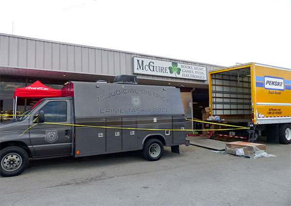 The law enforcement search at McGuire—a store that sells used books, compact discs, digital video discs, and electronics—is expected to last hours and continue throughout the night Thursday May 24, 2018. (Photo by John Huotari/Oak Ridge Today)