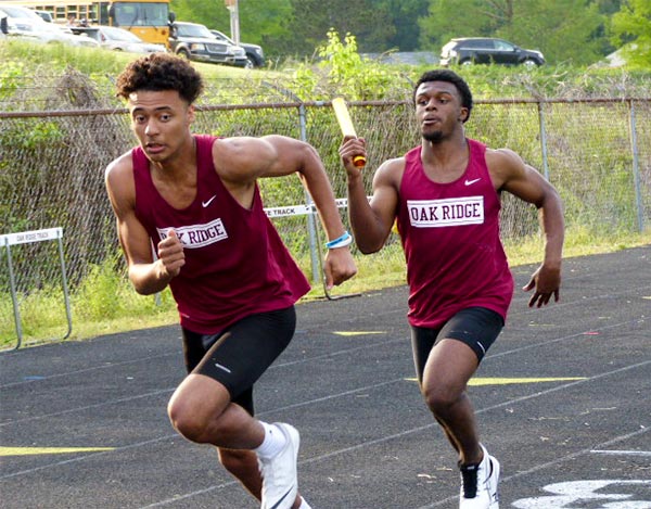 Pictured above during a track meet at Oak Ridge High School on May 4 are juniors Isaiah Goskowicz, left, and Jordan Graham, who qualified for the state championship track meet in Murfreesboro on Thursday, May 24, 2018, as part of the boys 4x100-meter relay team. (Photo by John Huotari/Oak Ridge Today)