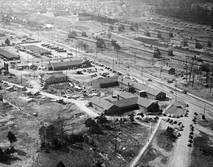 This aerial picture taken by government photographer Ed Westcott in 1943 shows the L-shaped Tunnell Building on Oak Ridge Turnpike at bottom-center, the Bus Terminal Road building up and to the left of it, Security Square past that, and the Red Cross building across from the Tunnell Building. There are dormitories on the other side of Oak Ridge Turnpike, in the area now occupied by the Methodist Medical Center campus. (Photo by Ed Westcott shared by Don and Emily Hunnicutt)