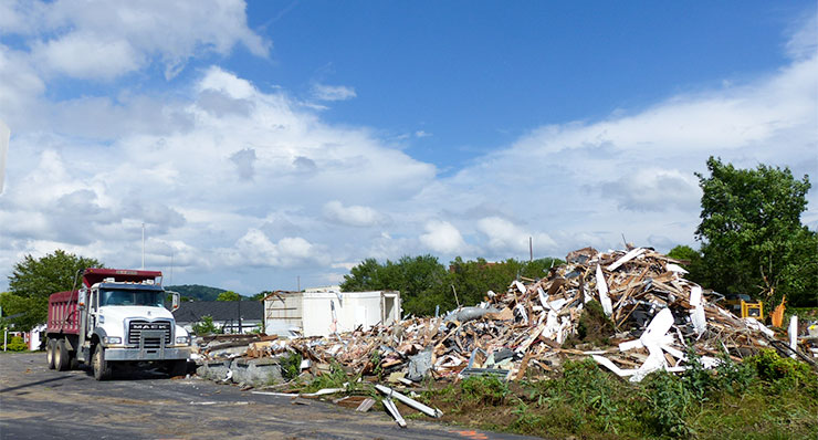 A building that was mostly demolished on Wednesday, May 30, 2018, once helped to protect enriched uranium at Y-12, and it was used by military police and the Oak Ridge Police Department to help protect the city. Part of the building, a former secure federal communications center, was still standing among the demolition debris late Wednesday afternoon. This picture was taken looking southeast from near the intersection of Bus Terminal Road and Oak Ridge Turnpike. (Photo by John Huotari/Oak Ridge Today)