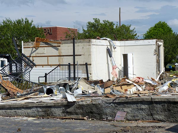 A building that was mostly demolished on Wednesday, May 30, 2018, once helped to protect enriched uranium at Y-12, and it was used by military police and the Oak Ridge Police Department to help protect the city. Part of the building, a former secure federal communications center, pictured above was still standing among the demolition debris late Wednesday afternoon. It included a heavy, bulletproof steel door and two holding cells. (Photo by John Huotari/Oak Ridge Today)