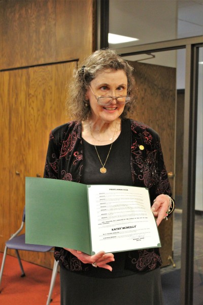 Oak Ridge Public Library Director Kathy McNeilly holds an Oak Ridge City Council proclamation in her honor at her retirement celebration on Friday, June 15, 2018. (Photo by City of Oak Ridge)