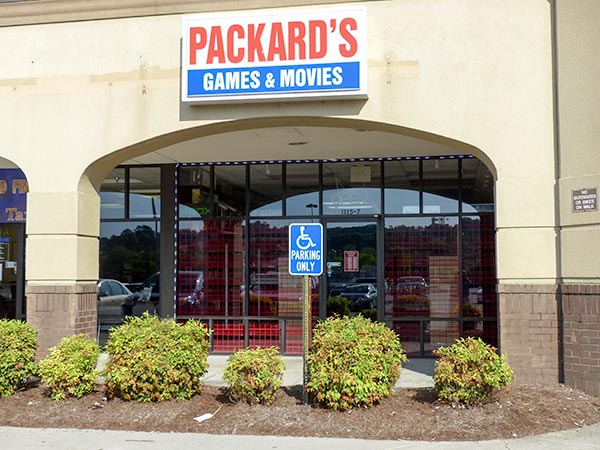 One employee near Packard's Games and Movies in Clinton said last week's search, which included the Clinton Police Department, a task force, and what appeared to be undercover officers, started around lunchtime Thursday, May 24, 2018, and continued all day, past 7:30 p.m., with boxes being loaded into a Penske truck. The store was reported to have closed for a few days but has since re-opened. (Photo by John Huotari/Oak Ridge Today)