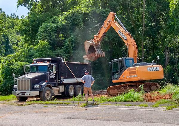 After a years-long dispute over alleged code violations, the 13 Applewood Apartments buildings on Hillside Road and Hunter Circle have been demolished. A Brady Excavating and Demolition crew removes the last basement on West Hunter Circle on Monday, July 9, 2018. (Photo by John Huotari/Oak Ridge Today)