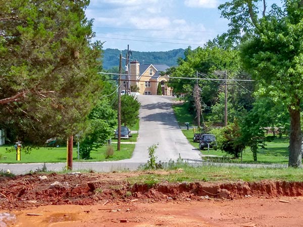 After a years-long dispute over alleged code violations, the 13 Applewood Apartments buildings on Hillside Road and Hunter Circle have been demolished. The site of one former building at Hillside Road and West Hunter Circle is pictured above on Monday, July 9, 2018, looking south down West Hutchinson Circle. (Photo by John Huotari/Oak Ridge Today)