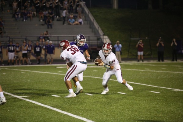 Oak Ridge sophomore quarterback Mitchell Gibbons (14) runs behind a block by sophomore Trey Rowe (36) during a 41-13 win at Sevier County on Friday, Sept. 21, 2018. (Photo by Luther Simmons)