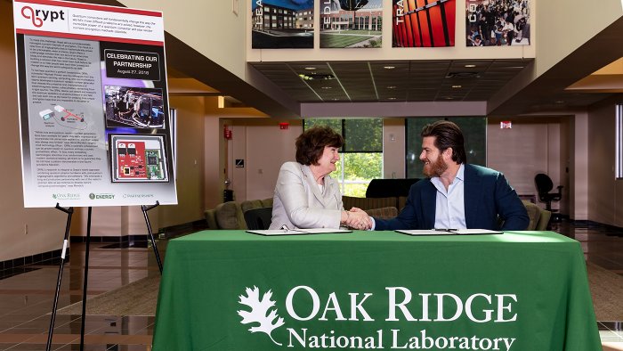Oak Ridge National Laboratoryâ€™s Michelle Buchanan, left, and Qrypt founder and CEO Kevin Chalker signed a licensing agreement for novel cyber security technology that promises a stronger defense against cyberattacks including those posed by quantum computing. (Photo credit: Carlos Jones/Oak Ridge National Laboratory, U.S. Department of Energy)