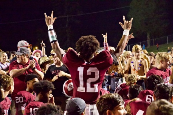 Oak Ridge senior Kai'Reese Pendergrass (12) celebrates with students, fans, parents, and friends after a 41-12 Wildcats win over Dobyns-Bennett on Blankenship Field on Friday, Aug. 24, 2018. (Photo by Barry Houchin)