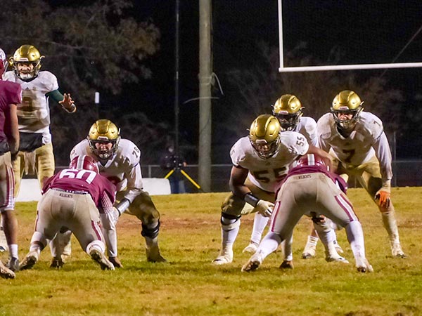 The Catholic offense lines up against the Oak Ridge defense during a 42-40 win for the Fighting Irish in a Class 5A quarterfinal game on Blankenship Field on Friday, Nov. 16, 2018. From left for the Fighting Irish are junior quarterback Jack Jancek (3) and junior linemen Cooper Mays (78), Bryn Tucker (55), and Stiles Moore (7). (Photo by John Huotari/Oak Ridge Today)