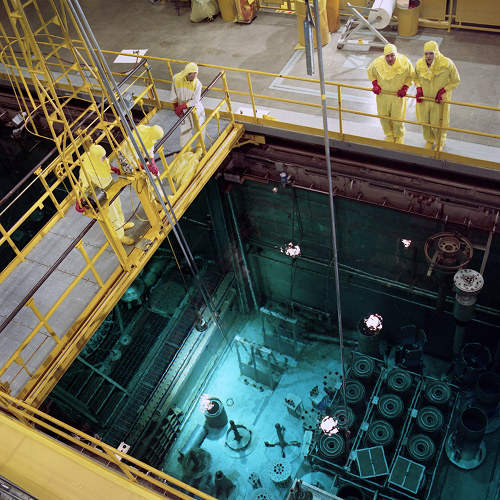 The High Flux Isotope Reactor vessel at Oak Ridge National Laboratory resides in a pool of water illuminated by the blue glow of the Cherenkov radiation effect. (Photo courtesy ORNL)