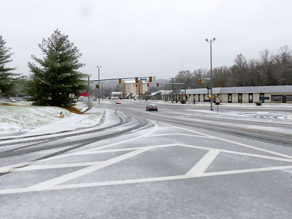 Many roads in Oak Ridge were covered by a wet, slushy snow on Sunday morning, Dec. 9, 2018, and some were slippery even when they appeared relatively clear. Pictured above is South Illinois Avenue near ORAU. (Photo by John Huotari/Oak Ridge Today)