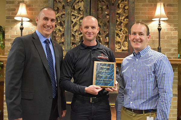 Roane State paramedic program director David Blevins, left, and Dr. Todd Heffern with TEAMHealth, right, congratulate Brandon Payne of Oak Ridge, Roane Stateâ€™s Paramedic Student of the Year. (Submitted photo)