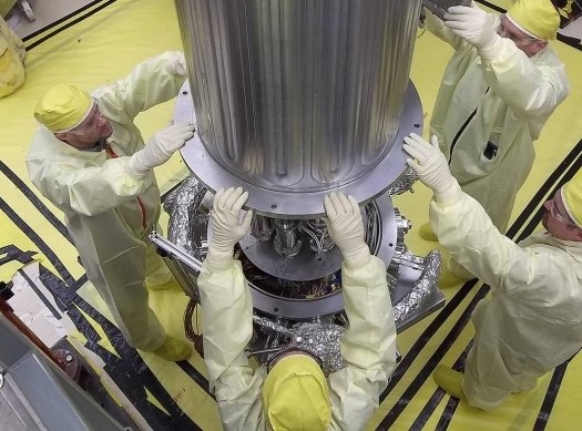 NASA and NNSA engineers lower the wall of the vacuum chamber around the KRUSTY system, which tested a new nuclear power source that could provide safe, efficient energy for future robotic and human space exploration missions. The vacuum chamber is later evacuated to simulate the conditions of space when KRUSTY operates. (Photo courtesy NASA)