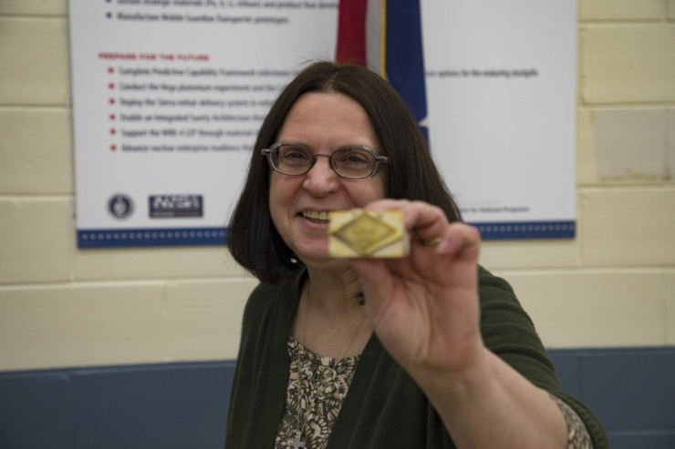 Donna Riggs of the NNSA Production Office stamped the first production unit of the B61-12 to indicate it was certified. (Photo courtesy CNS Y-12)
