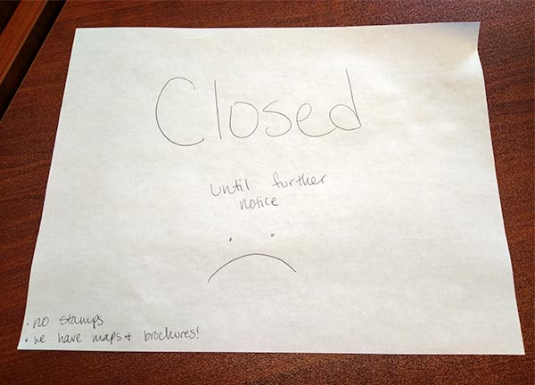 The partial government shutdown that started three weeks ago has affected the National Park Service in Oak Ridge. There are no National Park Service staff members or volunteers working at the Park Service desk at the Children's Museum of Oak Ridge. A sign on the National Park Service desk on Friday, Jan. 11, 2019, said "Closed until further notice," with a simple sketch of a frowning face underneath it. (Photo by John Huotari/Oak Ridge Today)